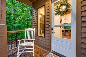Covered front porch with rocking chair and welcoming private entrance