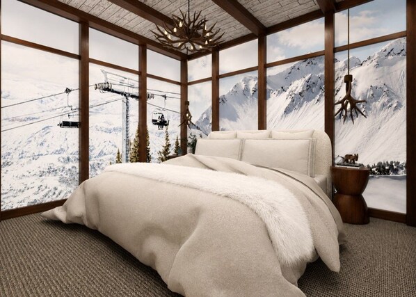 A bedroom with a large bed, wooden beams, and a mountain view through the windows.