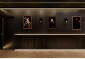 A hallway with three framed portraits on the wall, each with a small wall-mounted light. - Voyage Grand 14 BD/ 15.5 BA/ Paradiso Grande (6091 HS) (Orlando)