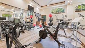 A gym with various exercise equipment, including treadmills, stationary bikes, and weight machines. - Saint James Place 214 (Beaver Creek)