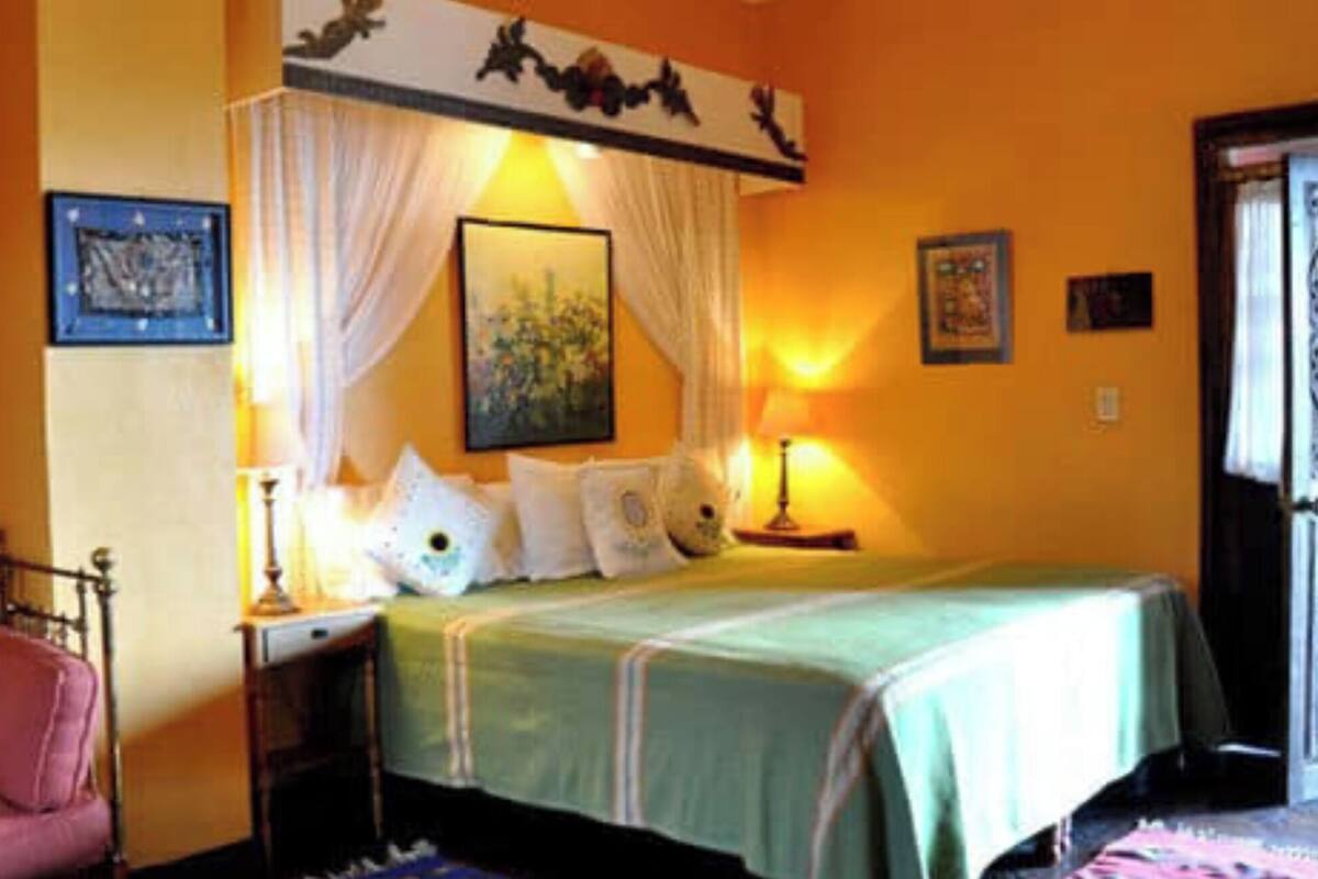 Ein Schlafzimmer mit Bett, Nachttisch, Stuhl und Tür.