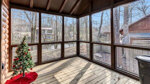 A corner room with large windows, a wooden floor, and a small Christmas tree. - New Tiny Home w/Creek Near Gburg (Cosby)