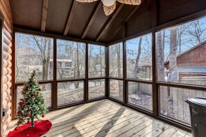 A corner room with large windows, a wooden floor, and a small Christmas tree. - New Tiny Home w/Creek Near Gburg (Cosby)