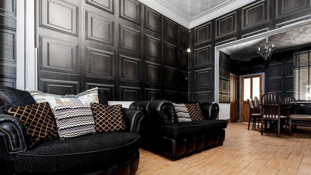 Una habitación con paredes revestidas de paneles oscuros, un sofá de cuero negro y una mesa de comedor de madera con sillas.