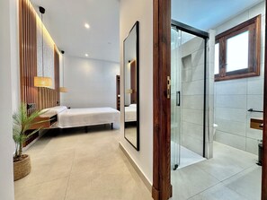 A modern hotel room with a bed, bedside table, lamp, and a potted plant. - GOLF SEA&POOL CACTUS VILLA (Buenavista del Norte)