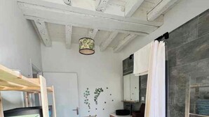 A modern bathroom with a wooden ceiling, a large mirror, and a shower curtain. - New, modern, fully-equipped home (La Ferté-Saint-Cyr)