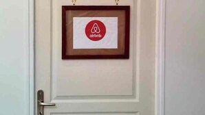 A white door with a framed Airbnb logo. - New, modern, fully-equipped home (La Ferté-Saint-Cyr)