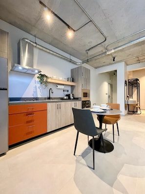 Enjoy meals in the kitchen with a central island, sink, stove, and microwave, surrounded by ample storage and a dining area.
