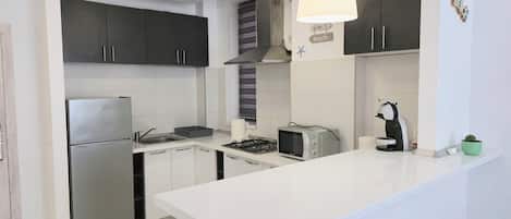 Fridge, microwave, stovetop, coffee/tea maker