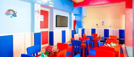 A children's playroom with colorful furniture and decorations.