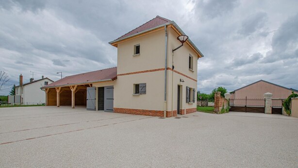 A two-story building with a covered garage and a fenced yard. - Number 1 - MORVILLIERS (MORVILLIERS)