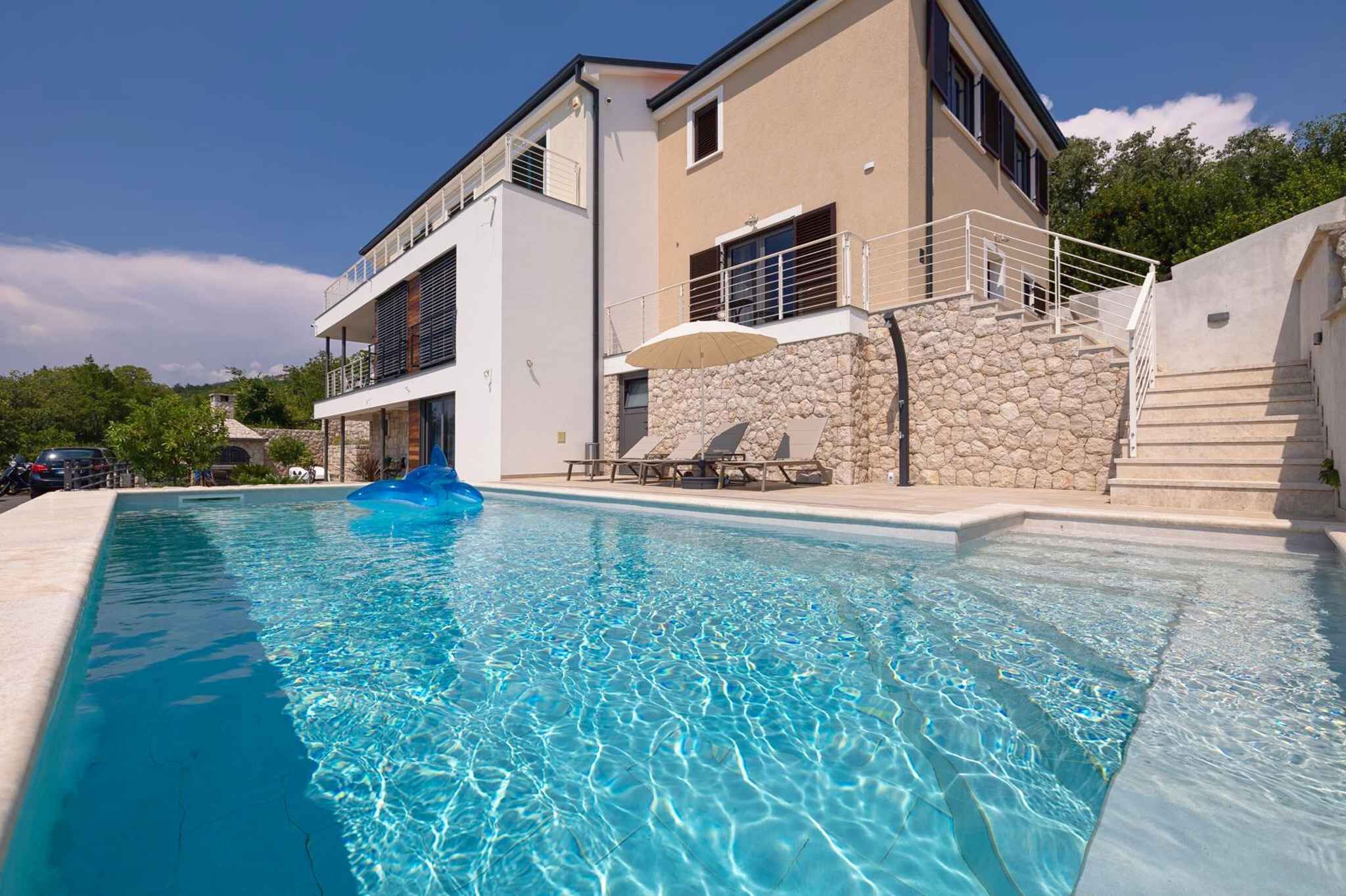 A modern two-story building with a swimming pool.