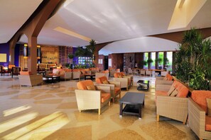 A spacious lobby with wicker furniture, a bar area, and large windows allowing natural light. - Retac Qunay Dahab (Dahab)