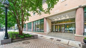 A building with a sign reading "300 PEACH TREE TOWERS" and a brick facade.