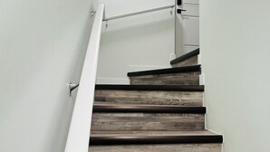 A staircase with wooden steps and white walls.