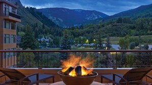 A balcony with a fire feature, overlooking a mountainous landscape. - Escape to the awe-inspiring beauty of Avon, Colorado and the Rockies (Avon)