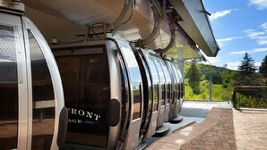 A row of metallic, cylindrical elevators with a sign that reads "FRONTAGE" on one of them. - Escape to the awe-inspiring beauty of Avon, Colorado and the Rockies (Avon)
