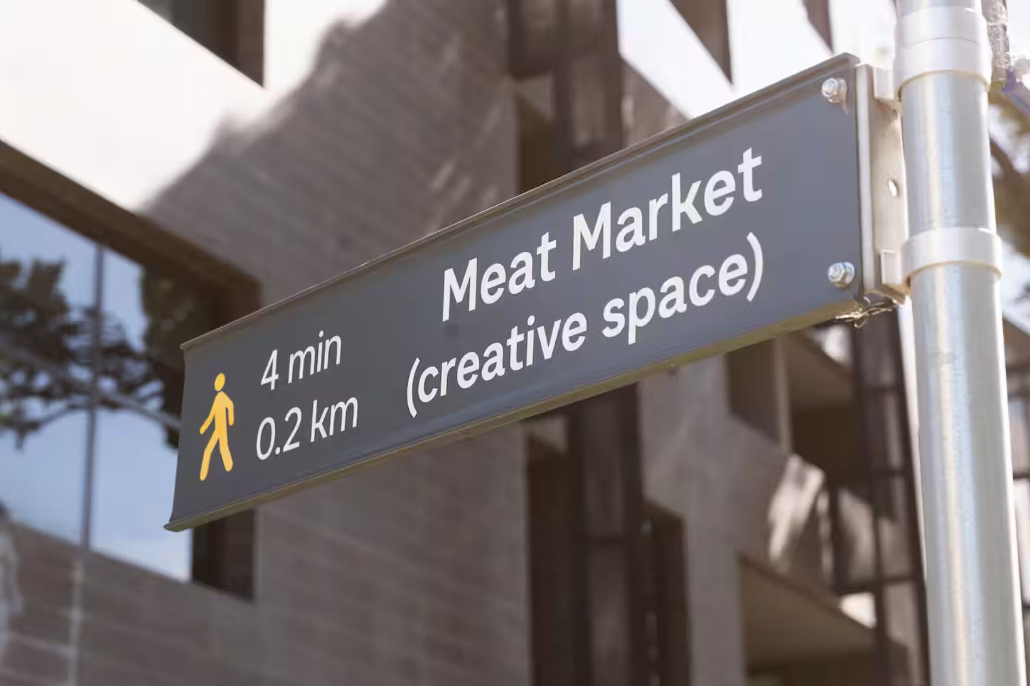 A sign indicating the Meat Market is 4 minutes and 0.2 km away.