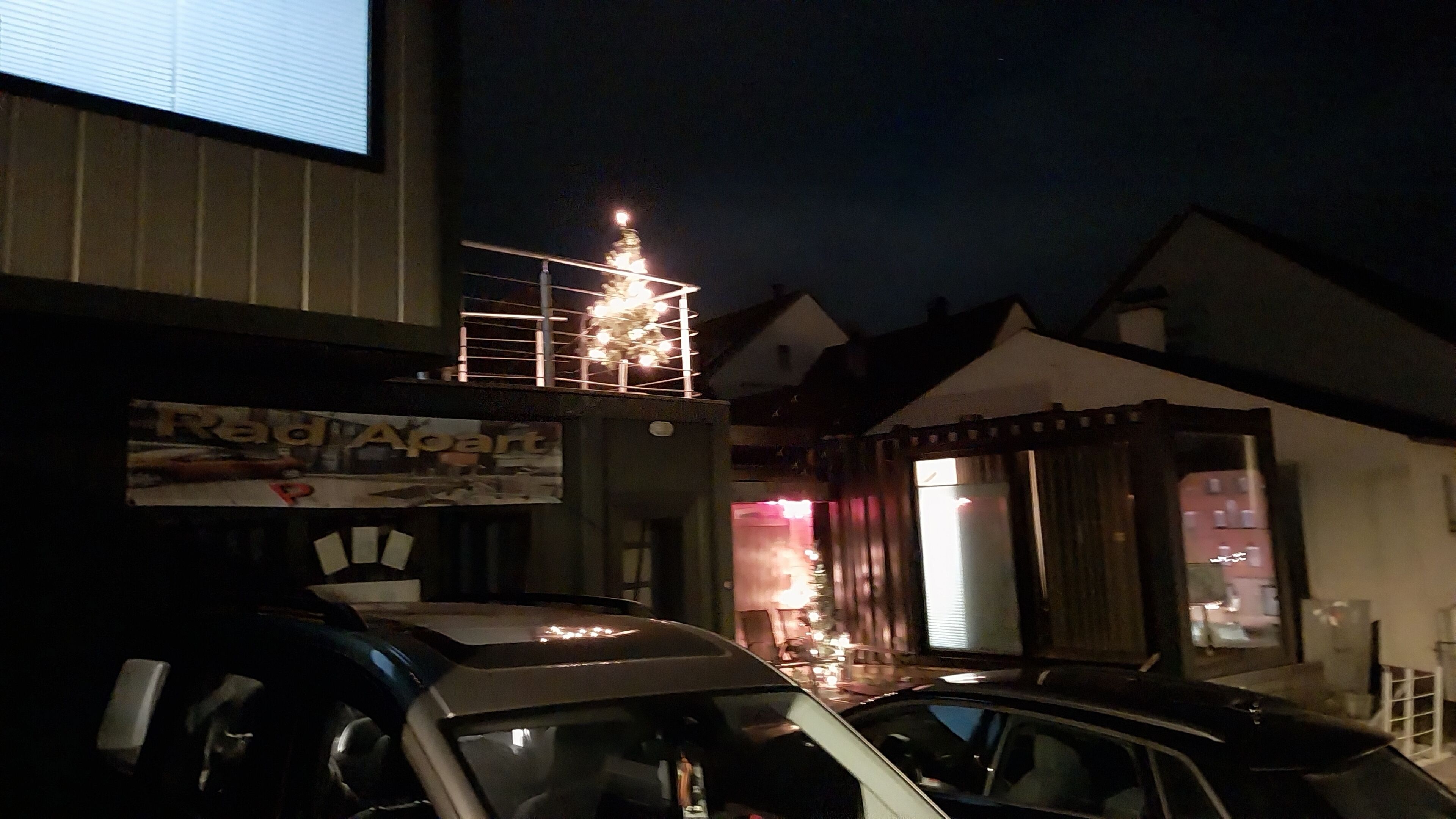 A building with a sign that reads 'Radapart' and a car parked in front.