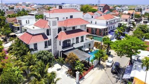 A residential area with modern houses featuring red-tiled roofs and balconies. - Vooc Signature Hotel Hoi An (Da Nang)