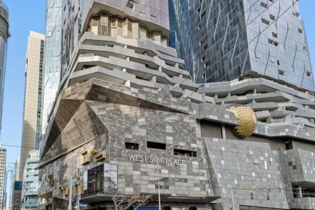 A modern building with a unique angular design, labeled "WEST SIDE PLACE."