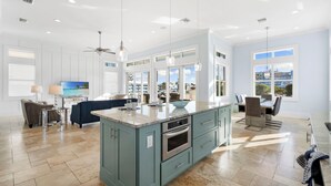 A spacious kitchen with a large island, modern appliances, and ample natural light from large windows. - Seaside Villa Aqua luxury 4-bedroom villa in Fort Myers Beach incredible view (Fort Myers Beach)