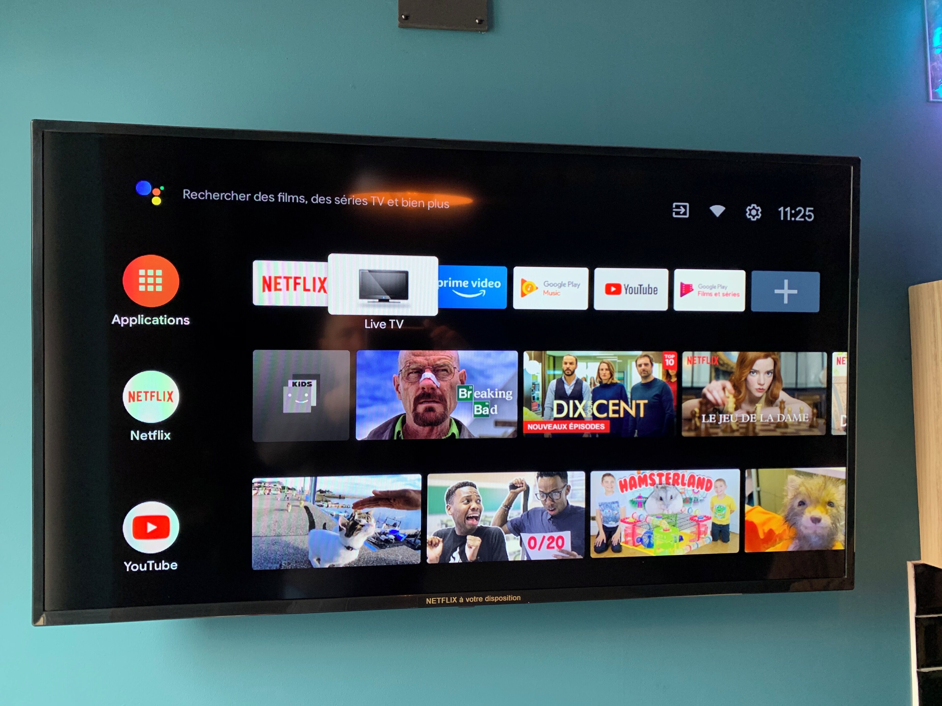 A television screen displaying various streaming services and live TV options.