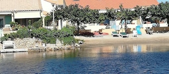 House on the edge of a marine pond close to the beach