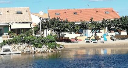 House on the edge of a marine pond close to the beach