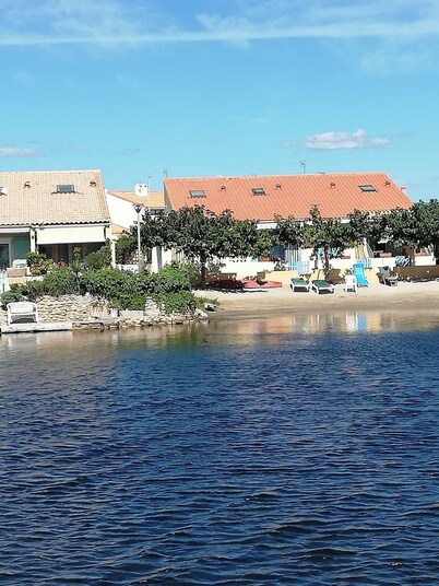 House on the edge of a marine pond close to the beach