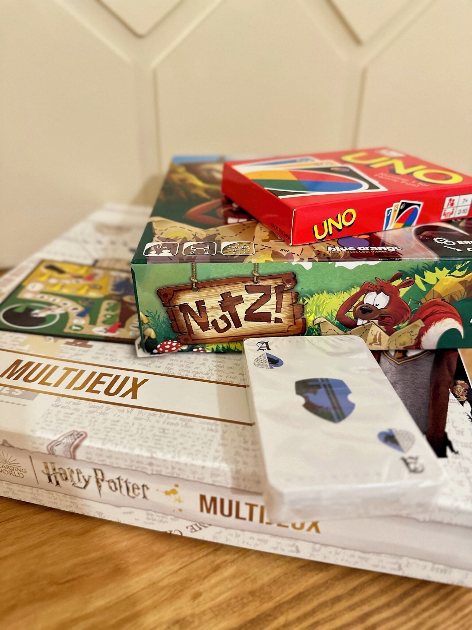 A table with various board games and cards, including UNO and a Harry Potter-themed game.