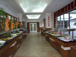A buffet area with multiple food stations, a central doorway, and decorative wall panels. - Mir'amor Hotel & Spa - All inclusive (Kemer)