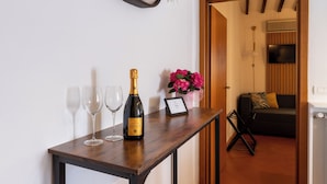 Una mesa de madera con una botella de champán, dos copas de vino y un certificado enmarcado.
