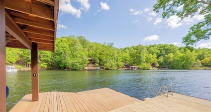 Private lakefront home with dock, forest views, balconies, game room, and cozy indoor charm
