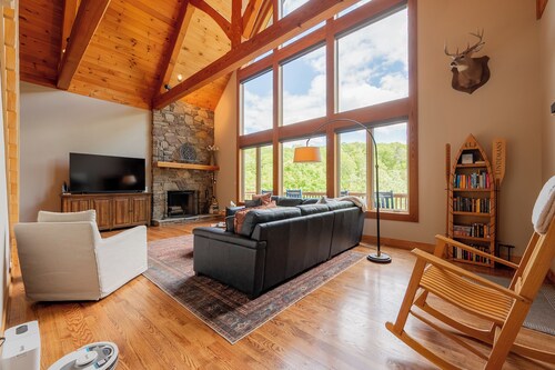 Private lakefront home with dock, forest views, balconies, game room, and cozy indoor charm