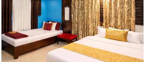 Chambre triple Deluxe | SystĂšme dâinsonorisation, literie fournie