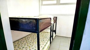 A small room with a single bed, a window, and a tiled floor. - Apartment Florencia With Pool & Wifi in Puerto del Carmen, Lanzarote (Tías)
