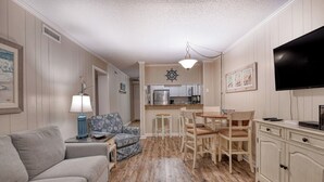 A compact living space with a kitchenette, a dining area, and a seating area. - Sea Oaks 308 - Two Bedroom, Two Bath Corner Oceanfront Condo (Garden City Beach)