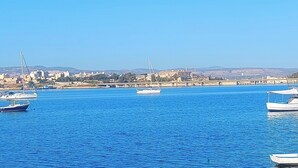 A marina with several boats docked, a bridge in the background, and a cityscape across the water. - Fabulous apartment, sea view ideal for families & groups of friends. (Augusta)