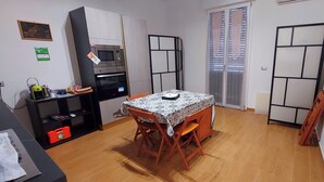 A compact kitchen with a microwave, oven, and a small dining table with chairs. - Fabulous apartment, sea view ideal for families & groups of friends. (Augusta)