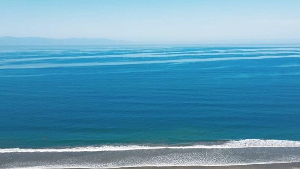 A beach with a clear view of the ocean and distant land. - Sleeps 6, Views & Beach 1 Block (Nuevo Vallarta)