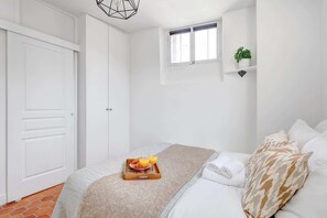 1 bedroom, desk, iron/ironing board, travel crib