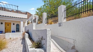 Un edificio con fachada blanca, una puerta de madera y un cartel que indica 'SOUTH WING'.