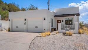 A modern building with two garage doors labeled "North Parking" and "South Parking." - Foothills Casita | Summer Mountain Retreat (Oro Valley)