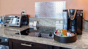 A kitchenette with a toaster, coffee maker, and a bowl of snacks. - Foothills Casita | Summer Mountain Retreat (Oro Valley)