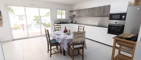 Enjoy cooking in this well-lit kitchen with a central island, sink, and microwave above.