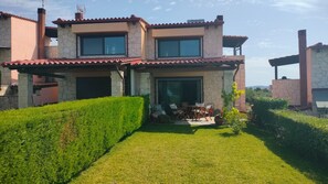 Relax in a peaceful setting with a patio area and beautifully maintained lawn.