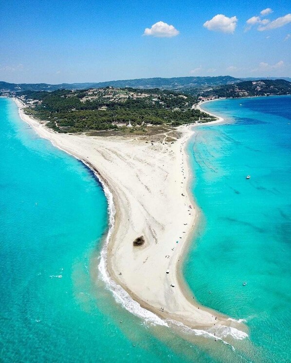 Enjoy a serene beachside setting with access to the turquoise waters and surrounding hills.