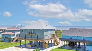 Une maison située sur la côte, dotée d’une terrasse, d’un espace abrité et offrant une vue sur l’océan.
