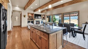A spacious kitchen with wooden beams, granite countertops, and a large island. - Ski & Golf Retreat w/ Stunning Mountain Views (Eden)